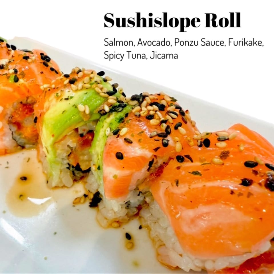 Sushislope Roll with salmon, avocado, ponzu sauce, furikake, spicy tuna, and jicama on a white plate.