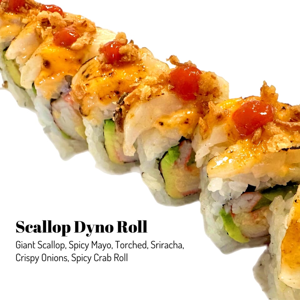 A Scallop Dyno Roll from Sushi Friend, topped with spicy mayo, torched scallop, sriracha, and crispy onions.