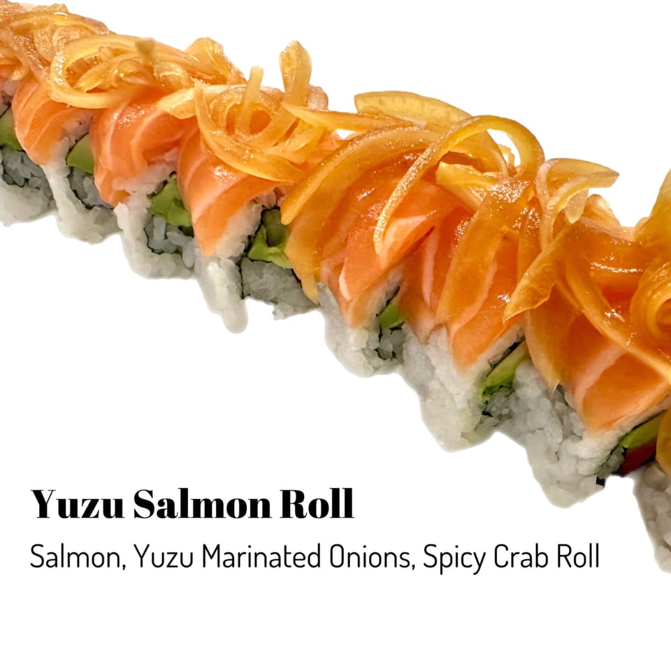 Yuzu Salmon Roll with salmon, yuzu marinated onions, and spicy crab on a white background.